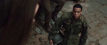 Movie still from “Miracle at St. Anna” (2008), directed by Spike Lee – A man in a military uniform holding a helmet; Close Up shot, High angle