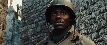Movie still from “Miracle at St. Anna” (2008), directed by Spike Lee – A man in a military uniform wearing a helmet; Close Up shot, Low angle