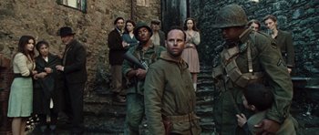 Movie still from “Miracle at St. Anna” (2008), directed by Spike Lee – A group of men and women standing next to each other on some steps; Medium shot, Over the shoulder angle