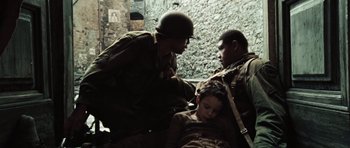 Movie still from “Miracle at St. Anna” (2008), directed by Spike Lee – A group of men standing next to each other in a room; Medium shot, High angle