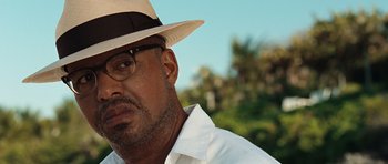 Movie still from “Miracle at St. Anna” (2008), directed by Spike Lee – A person wearing glasses and a hat; Close Up shot, Low angle