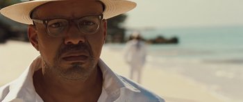 Movie still from “Miracle at St. Anna” (2008), directed by Spike Lee – A person wearing glasses and a hat; Close Up shot, Over the shoulder angle
