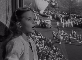 Movie still from “Miracle on 34th Street” (1947), directed by George Seaton – A young girl standing in front of a crowd of onlookers; Medium shot, Low angle