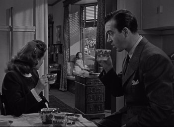 Movie still from “Miracle on 34th Street” (1947), directed by George Seaton – A man and a woman sitting at a table drinking coffee; Medium shot, High angle