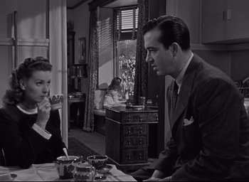 Movie still from “Miracle on 34th Street” (1947), directed by George Seaton – A man and a woman sitting at a dining room table; Medium shot, High angle