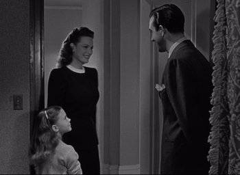 Movie still from “Miracle on 34th Street” (1947), directed by George Seaton – A man and a woman and a little girl standing next to each other; Medium shot, Over the shoulder angle
