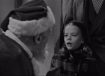 Movie still from “Miracle on 34th Street” (1947), directed by George Seaton – An old man and a little girl talking to each other; Close Up shot, Over the shoulder angle