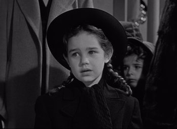 Movie still from “Miracle on 34th Street” (1947), directed by George Seaton – A young girl wearing a black hat and a black coat; Close Up shot, High angle