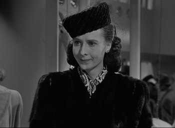 Movie still from “Miracle on 34th Street” (1947), directed by George Seaton – An old photo of a woman wearing a hat and a fur coat; Close Up shot, Over the shoulder angle