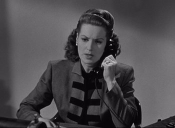 Movie still from “Miracle on 34th Street” (1947), directed by George Seaton – A woman is talking on a phone while sitting down; Close Up shot, High angle