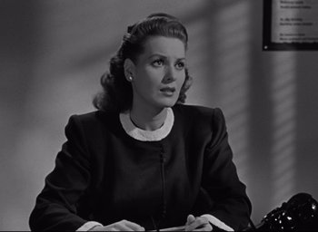Movie still from “Miracle on 34th Street” (1947), directed by George Seaton – An old black and white photo of a woman sitting at a desk; Close Up shot, Low angle