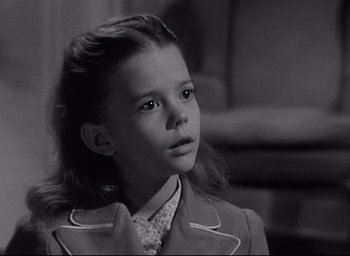 Movie still from “Miracle on 34th Street” (1947), directed by George Seaton – A young girl is looking at the camera; Close Up shot, High angle