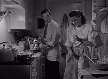 Movie still from “Miracle on 34th Street” (1947), directed by George Seaton – A man and a woman in a kitchen preparing food; Medium shot, High angle