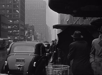 Movie still from “Miracle on 34th Street” (1947), directed by George Seaton – A black and white photo of a busy city street; Wide shot, Low angle