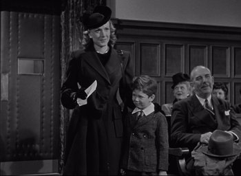 Movie still from “Miracle on 34th Street” (1947), directed by George Seaton – An old photo of a woman and a boy; Medium shot, Low angle