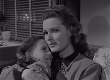 Movie still from “Miracle on 34th Street” (1947), directed by George Seaton – A woman holding a little girl in her arms; Close Up shot, Over the shoulder angle