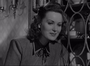 Movie still from “Miracle on 34th Street” (1947), directed by George Seaton – A black and white photo of a woman in a suit; Close Up shot, Low angle