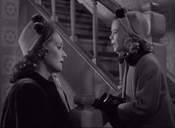 Movie still from “Miracle on 34th Street” (1947), directed by George Seaton – Two women are talking to each other on the stairs; Medium shot, Over the shoulder angle