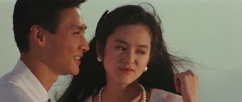 Movie still from “Miracles: The Canton Godfather” (1989), directed by Jackie Chan – A man and a woman talking to each other; Close Up shot, Over the shoulder angle