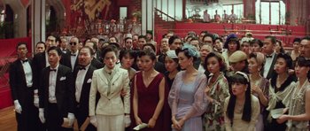 Movie still from “Miracles: The Canton Godfather” (1989), directed by Jackie Chan – A group of people standing in front of each other; Wide shot, High angle