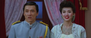 Movie still from “Miracles: The Canton Godfather” (1989), directed by Jackie Chan – A man and a woman standing next to each other; Close Up shot, Low angle