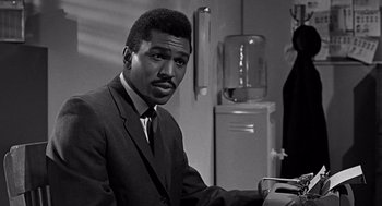 Movie still from “Mirage” (1965), directed by Edward Dmytryk – A black and white photo of a man in a suit and tie; Close Up shot, Low angle