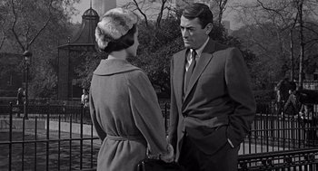 Movie still from “Mirage” (1965), directed by Edward Dmytryk – A man and a woman standing next to each other; Medium shot, Over the shoulder angle