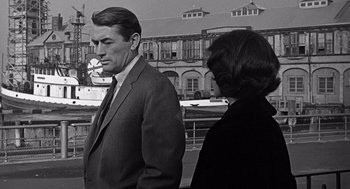 Movie still from “Mirage” (1965), directed by Edward Dmytryk – A black and white photo of a man and a woman; Medium shot, Over the shoulder angle