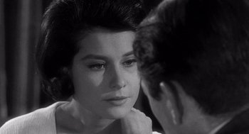 Movie still from “Mirage” (1965), directed by Edward Dmytryk – A black and white photo of a woman looking at a mirror; Close Up shot, Over the shoulder angle