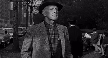 Movie still from “Mirage” (1965), directed by Edward Dmytryk – An older man wearing a hat and a suit; Medium shot, Low angle