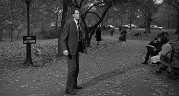 Movie still from “Mirage” (1965), directed by Edward Dmytryk – A black and white photo of a man in a suit and tie; Wide shot, Low angle