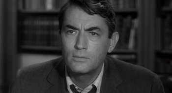 Movie still from “Mirage” (1965), directed by Edward Dmytryk – Black and white photograph of a man in a suit and tie; Close Up shot, High angle