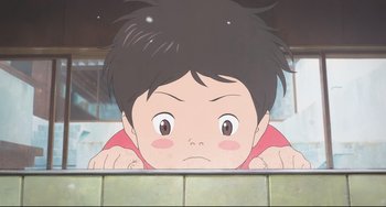 Movie still from “Mirai” (2018), directed by Mamoru Hosoda – A boy is looking over a wall in a cartoon; Close Up shot, Low angle