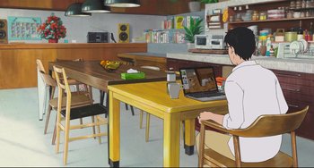Movie still from “Mirai” (2018), directed by Mamoru Hosoda – A person sitting at a table with a laptop; Extreme Wide shot, High angle