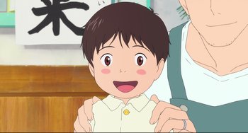 Movie still from “Mirai” (2018), directed by Mamoru Hosoda – An animated picture of a boy smiling for the camera; Close Up shot, Over the shoulder angle