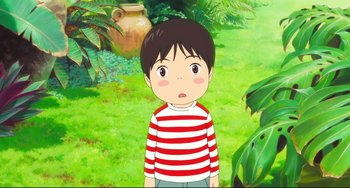 Movie still from “Mirai” (2018), directed by Mamoru Hosoda – A boy in a striped shirt is standing in the grass; Medium shot, High angle