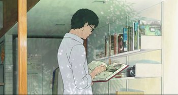 Movie still from “Mirai” (2018), directed by Mamoru Hosoda – A man is reading a book in a room with bookshelves; Medium shot, Over the shoulder angle