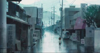 Movie still from “Mirai” (2018), directed by Mamoru Hosoda – A person walking down a street in the middle of the day; Extreme Wide shot, Low angle