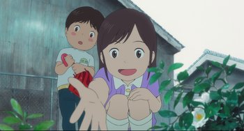 Movie still from “Mirai” (2018), directed by Mamoru Hosoda – A girl and a little boy are sitting in front of a building; Medium shot, Low angle