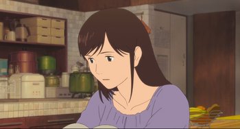 Movie still from “Mirai” (2018), directed by Mamoru Hosoda – An animated picture of a woman sitting in a kitchen; Close Up shot, Over the shoulder angle
