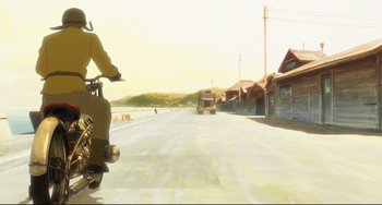 Movie still from “Mirai” (2018), directed by Mamoru Hosoda – A person riding a motorcycle down a street; Wide shot, Low angle