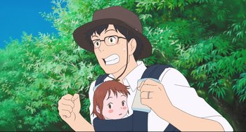 Movie still from “Mirai” (2018), directed by Mamoru Hosoda – An animated picture of a man holding a child; Medium shot, Low angle