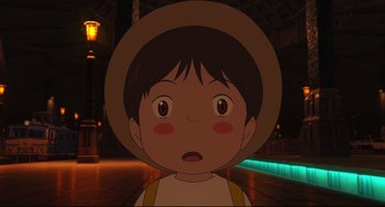 Movie still from “Mirai” (2018), directed by Mamoru Hosoda – A child with a hat is looking surprised; Close Up shot, High angle