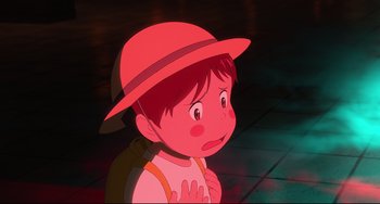 Movie still from “Mirai” (2018), directed by Mamoru Hosoda – A cartoon of a boy wearing a red hat; Close Up shot, High angle