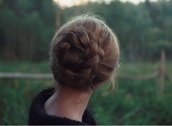 Movie still from “Mirror” (1975), directed by Andrei Tarkovsky – A person's hair in a bun; Close Up shot, Over the shoulder angle