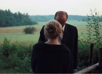 Movie still from “Mirror” (1975), directed by Andrei Tarkovsky – A man and a woman standing next to each other; Medium shot, Over the shoulder angle
