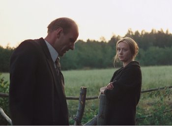 Movie still from “Mirror” (1975), directed by Andrei Tarkovsky – A man and a woman standing next to each other in a field; Medium shot, Over the shoulder angle