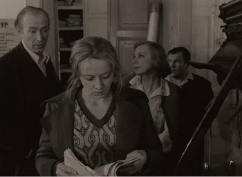 Movie still from “Mirror” (1975), directed by Andrei Tarkovsky – A group of people standing in a room; Medium shot, Over the shoulder angle