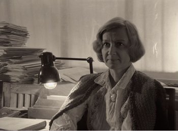 Movie still from “Mirror” (1975), directed by Andrei Tarkovsky – An older woman sitting in front of a lamp; Medium shot, High angle