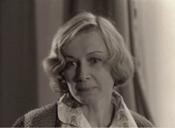 Movie still from “Mirror” (1975), directed by Andrei Tarkovsky – An old photo of an older woman with blonde hair; Close Up shot, High angle